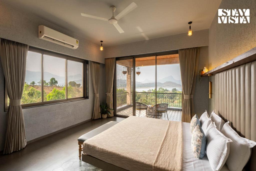 A quiet room opening onto still water and distant hills at first light